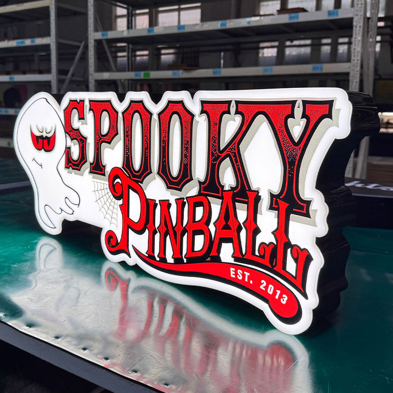 Custom LED Acrylic Logo Signs Factory batch production of custom LED acrylic signs on workbench including American Pinball, Williams, Barrels of Fun, and Spooky Pinball
